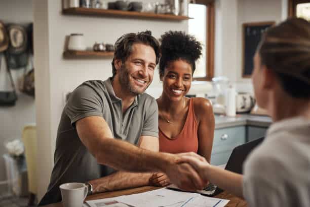 middle aged man shaking hands with a financial advisor during a consultation about second mortgage with bad credit at home