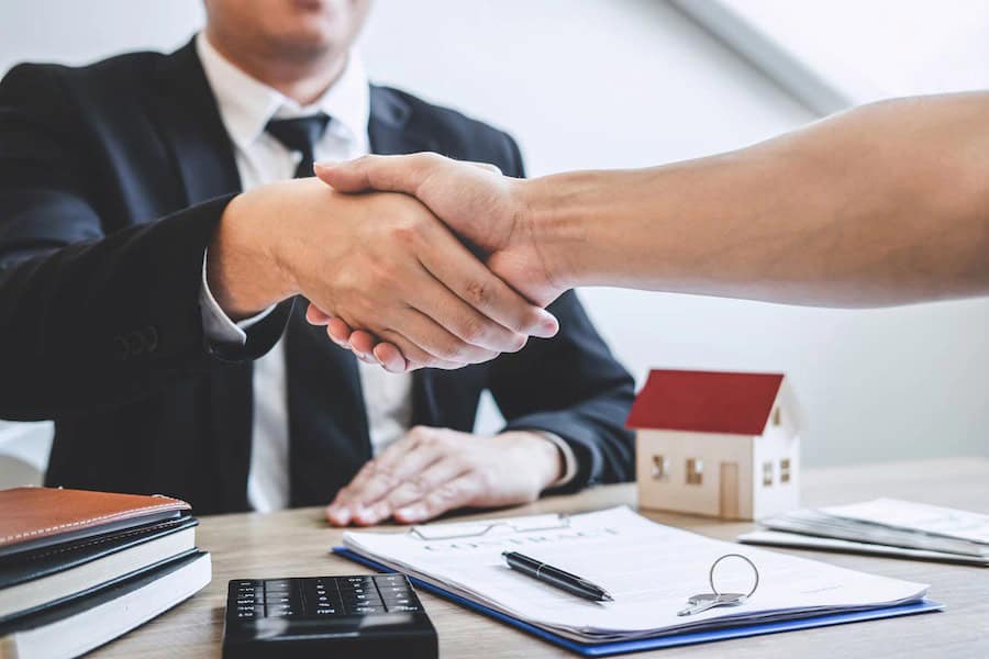 finishing successful deal real estate broker client shaking hands after signing contract approved ap - High Risk Mortgage Lenders - Approvals for Bad Credit & Low Income