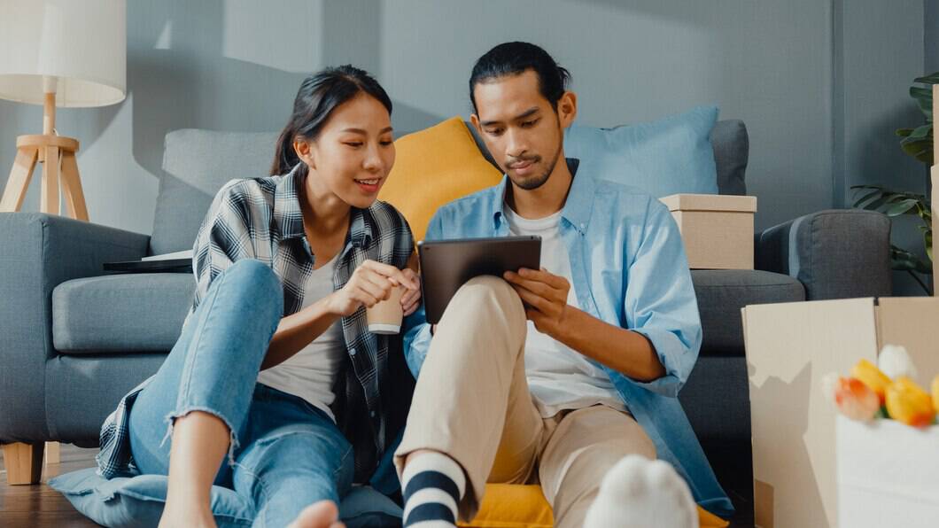 happy asian young couple man woman use tablet online shopping furniture decorate house with carton packages new house 7861 2951 - Secured Line of Credit - A Homeowner's Safety Net