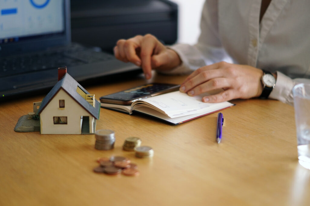 closeup shot person thinking buying selling house - Home Equity Calculator - How Much Can I Borrow Using My Equity?
