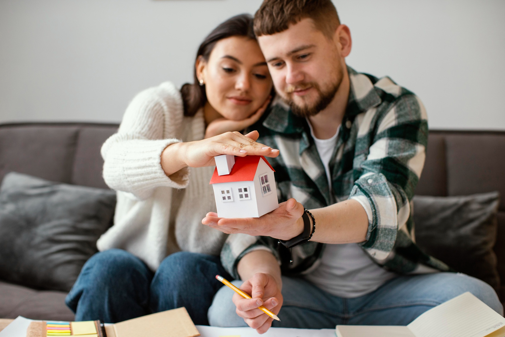 couple holding small house medium shot - Secured Line of Credit - A Homeowner's Safety Net