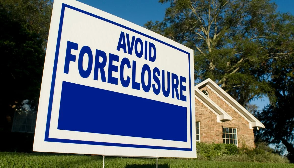 Avoid Foreclosure banner in front of the house