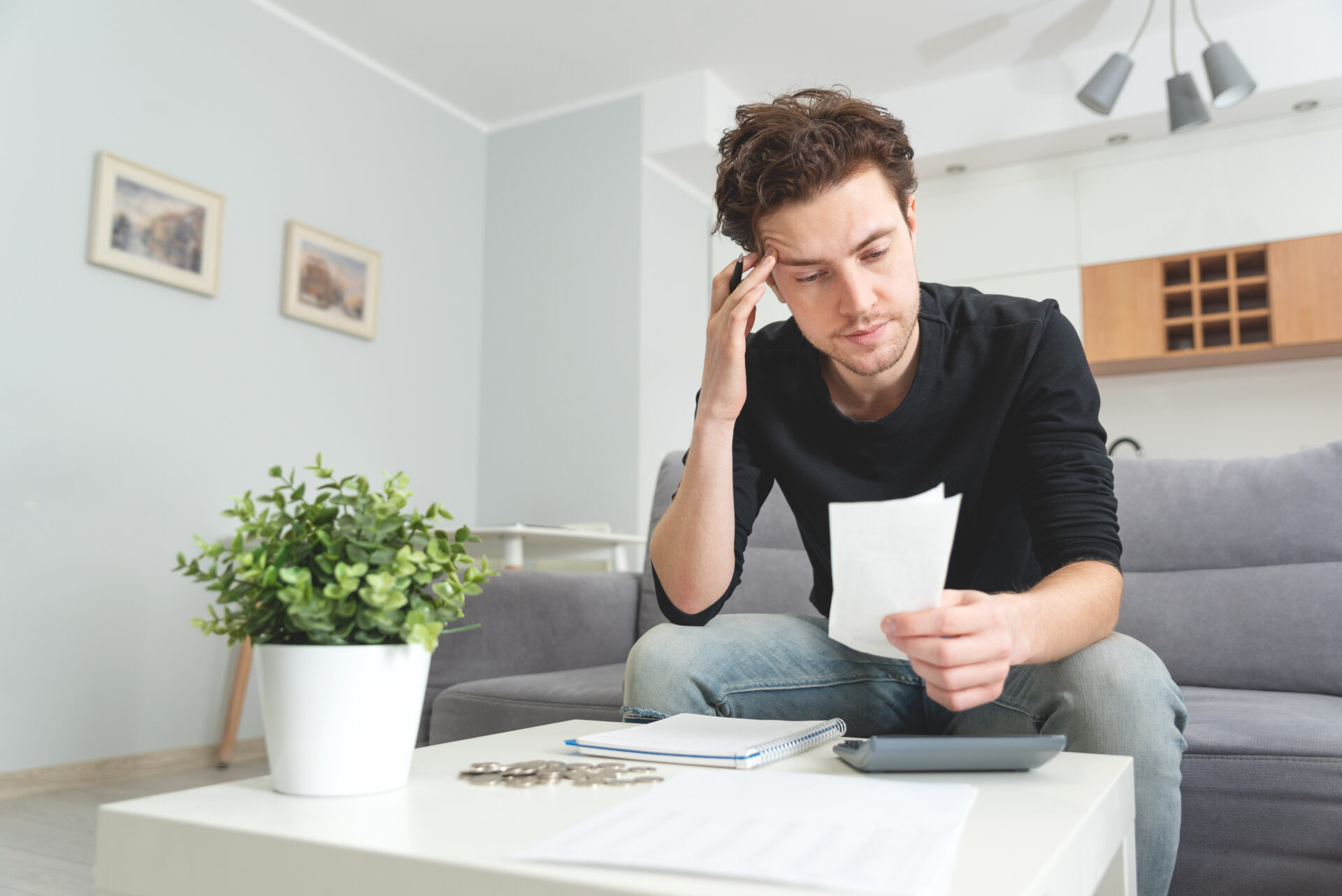 Man holding receipt, making financial revision heloc vs home equity loan