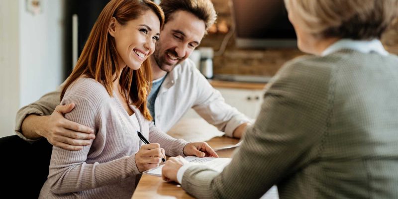 young-happy-woman-her-husband-signing-agreement-with-insurance-agent-during-meeting.jpg